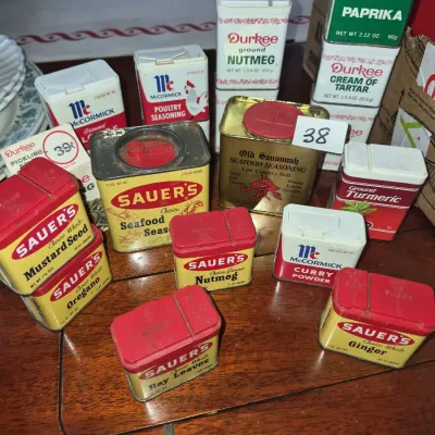 Sale Photo Thumbnail #59: Collection of vintage spice tins and containers, including Sauer's, McCormick, Durkee, and Old Savannah brands, showing age-appropriate surface wear.