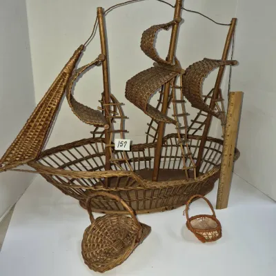 Sale Photo Thumbnail #275: Vintage woven wicker ship-shaped decorative basket alongside two small miniature handle baskets.