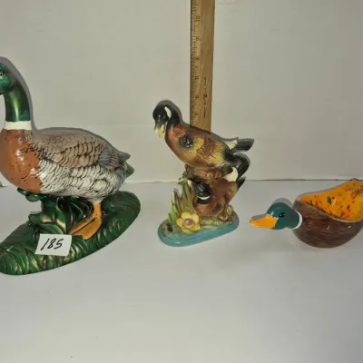 Sale Photo Thumbnail #317: Set of three vintage painted ceramic duck figurines and a duck-shaped dish, featuring detailed mallard and waterfowl designs.