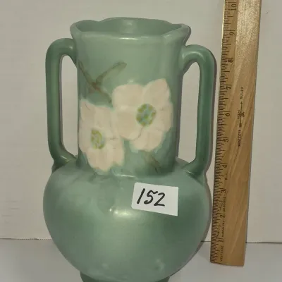 Sale Photo Thumbnail #259: Roseville Pottery Clematis double-handled vase in green, standing approximately nine inches tall with painted white floral details.