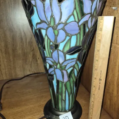 Sale Photo Thumbnail #32: Stained glass cone-shaped accent lamp with a blue and purple iris flower motif, standing approximately 12 inches tall.