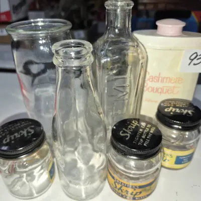 Sale Photo Thumbnail #149: Collection of vintage glass bottles, including three Sheaffer's Skrip ink jars with original caps and labels, a small milk bottle, and a vintage Cashmere Bouquet talcum container.