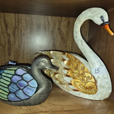Sale Photo Thumbnail #25: Tiffany-style stained glass duck accent lamp alongside a capiz shell and embossed brass swan figurine.