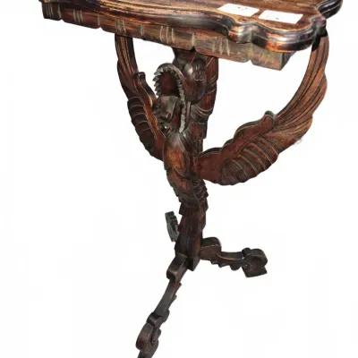 Sale Photo Thumbnail #124: Hand-carved wooden accent table featuring a winged dragon pedestal base, scalloped top, and tripod feet.