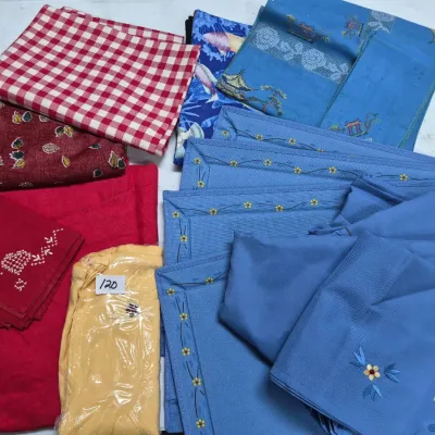 Sale Photo Thumbnail #199: Collection of vintage table linens, including blue embroidered placemats, red and white gingham fabric, embroidered cloth napkins, and printed textiles.