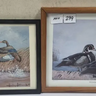 Sale Photo Thumbnail #532: Pair of framed waterfowl art prints, including a 13x10-inch mallard scene signed Headley Adelmann '88 and a 14x11-inch wood duck print titled "Woodies" by Nigel Shaw.