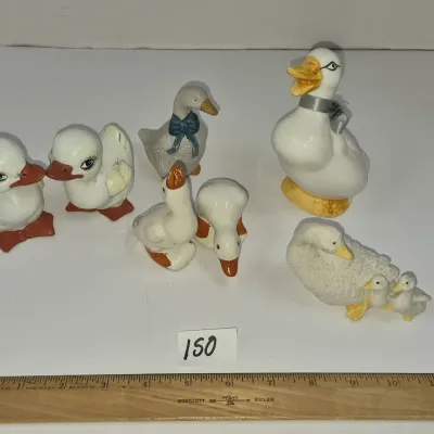 Sale Photo Thumbnail #256: Collection of seven vintage ceramic duck and goose figurines in various poses and sizes.