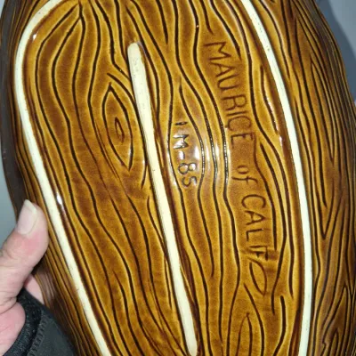 Sale Photo Thumbnail #569: Underside of a vintage Maurice of California ceramic dish featuring faux woodgrain texture and maker's mark M-85.