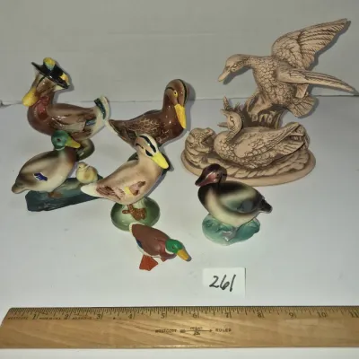 Sale Photo Thumbnail #445: Collection of vintage porcelain and ceramic duck figurines in various sizes, hand-painted finishes, and styles.