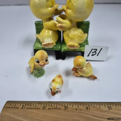 Sale Photo Thumbnail #213: Vintage ceramic duck family figurines, including a salt and pepper shaker set of yellow ducks on green benches and three miniature ducklings.