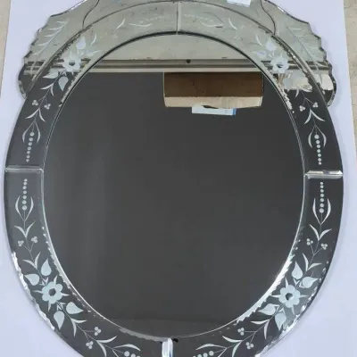 Sale Photo Thumbnail #586: Vintage Venetian-style oval wall mirror featuring etched floral motifs along the segmented border and an ornate crest.