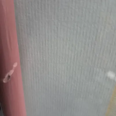 Sale Photo Thumbnail #529: Extreme close-up view of a pink painted post beside a light grey textured or ribbed surface.