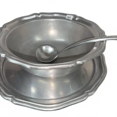 Sale Photo Thumbnail #638: Vintage pewter serving set, including a scalloped edge soup tureen or punch bowl, matching underplate, and long-handled ladle.