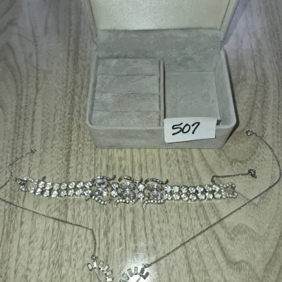 Sale Photo Thumbnail #873: Vintage rhinestone bracelet and delicate chain necklace displayed with a grey velvet jewelry box.