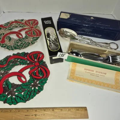 Sale Photo Thumbnail #339: Collection of vintage Christmas trivets and boxed serving utensils, including Gorham silverplated salad tongs and International Silver flatware.