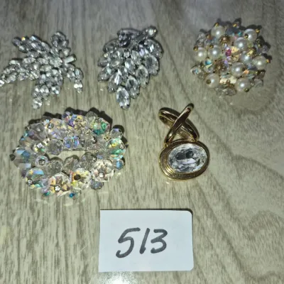 Sale Photo Thumbnail #886: Collection of five vintage costume jewelry brooches, including rhinestone, faux pearl, and aurora borealis crystal designs.