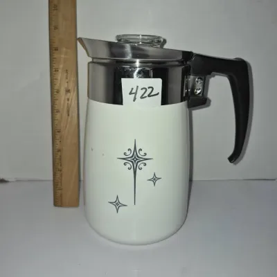 Sale Photo Thumbnail #737: Mid-century modern stove-top coffee percolator featuring a white body with atomic starburst graphics, stainless steel trim, and a black composite handle.