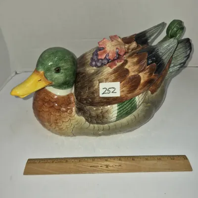 Sale Photo Thumbnail #429: Vintage Fitz and Floyd hand-painted mallard duck ceramic tureen with grape and leaf lid handle detail, measuring approximately 12 inches long.
