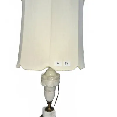 Sale Photo Thumbnail #139: Neoclassical style alabaster and brass table lamp featuring a carved urn-shaped body and square pedestal base, topped with a tall off-white fabric shade.