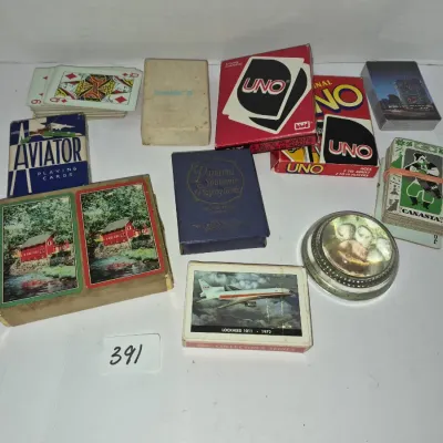 Sale Photo Thumbnail #684: Collection of vintage playing card decks, including Aviator, UNO, Panama Souvenir, and double-deck sets with pictorial cases.