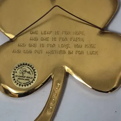 Sale Photo Thumbnail #766: Vintage Gerity Products 24 karat gold electroplate four-leaf clover wall plaque featuring an inscribed poem on the back, circa 1986.