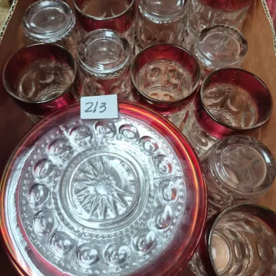 Sale Photo Thumbnail #365: Vintage King's Crown pattern glassware set featuring ruby flashed rims, including tumblers and a matching pitcher lid or bowl, displayed in a box.