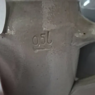 Sale Photo Thumbnail #610: Detail view of a gray stoneware beer stein showing the stamped 0.5L capacity mark.