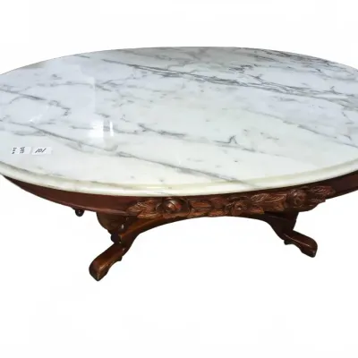 Sale Photo Thumbnail #158: Vintage oval marble-top coffee table featuring a carved dark wood frame with floral motifs.