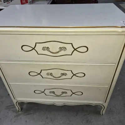 Sale Photo Thumbnail #147: French Provincial style three-drawer chest in cream finish with gold trim and ornate bail handles.