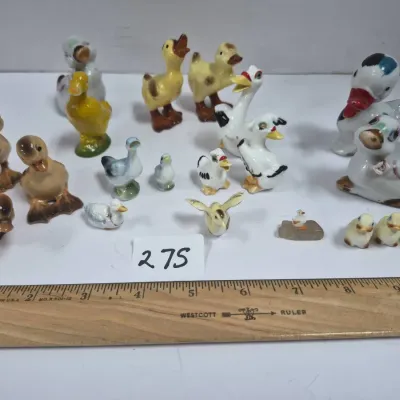 Sale Photo Thumbnail #465: Collection of vintage miniature ceramic duck, goose, and bird figurines in various sizes, colors, and poses.