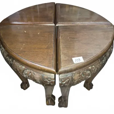 Sale Photo Thumbnail #164: Set of four vintage carved wood pie-slice nesting or accent tables featuring claw feet and detailed apron carvings, showing surface scratches from age.