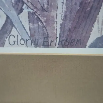 Sale Photo Thumbnail #493: Close-up detail of an artist's signature reading "Gloria Eriksen" on a framed, matted artwork.