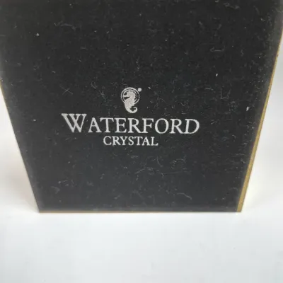 Sale Photo Thumbnail #458: Black felt-lined base of a Waterford Crystal item, featuring the silver printed seahorse logo.