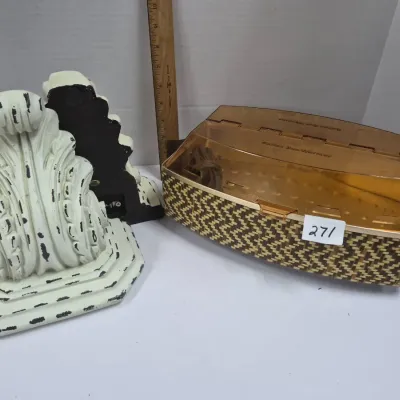 Sale Photo Thumbnail #460: Vintage Salton Bun Warmer with a woven basket-style design alongside a pair of distressed off-white acanthus leaf wall sconce brackets.