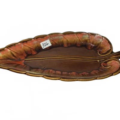 Sale Photo Thumbnail #568: Vintage Hull Pottery glazed ceramic leaf-shaped dish featuring a rich brown center with red and orange drip glaze detailing around the edges.