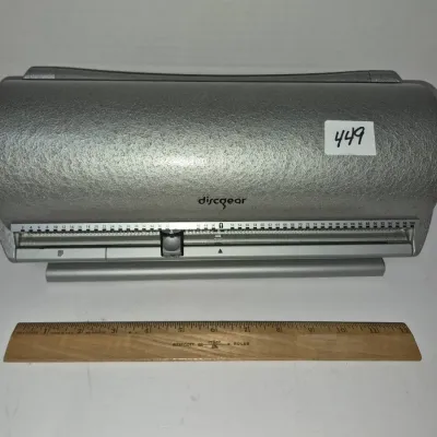 Sale Photo Thumbnail #777: Discgear 100-disc storage unit with textured silver finish, slider index selector, and a Westcott wooden ruler shown for scale.