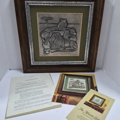 Sale Photo Thumbnail #594: Framed Franklin Mint sterling silver wall sculpture, "The African Lion" by Donald Richard Miller, complete with original promotional material and certificate of authenticity.