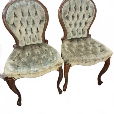 Sale Photo Thumbnail #111: Pair of Victorian Style balloon-back side chairs with tufted sage green upholstery and carved wooden frames.