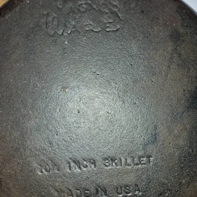 Sale Photo Thumbnail #626: Vintage Wagner Ware 10 1/2-inch cast iron skillet showing bottom markings including the stylized logo and "MADE IN USA".
