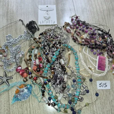 Sale Photo Thumbnail #888: Large collection of fashion jewelry including beaded necklaces, metal chains, bangles, and a star pendant, mostly contemporary styles.