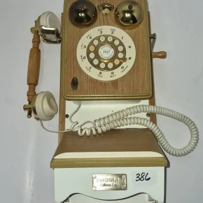 Sale Photo Thumbnail #676: Thomas Collector's Edition vintage-style wooden wall telephone featuring brass bells and a rotary-look push-button dial.