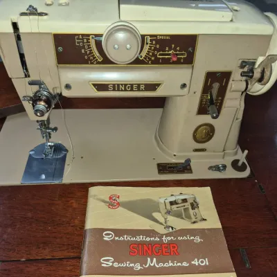 Sale Photo Thumbnail #53: Vintage Singer Slant-O-Matic 401 sewing machine in a wooden cabinet, complete with its original instruction booklet.