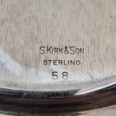 Sale Photo Thumbnail #902: Close-up view of S. Kirk & Son hallmark stamped on a sterling silver piece, model number 58.