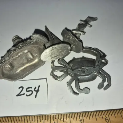 Sale Photo Thumbnail #434: Collection of vintage pewter miniatures, including a crab figurine by Fine Pewter and a lighthouse piece by Spoontiques dated 1985.