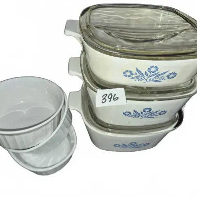 Sale Photo Thumbnail #694: Vintage Corning Ware Cornflower Blue pattern casserole dishes with glass lids, paired with a stack of three white ceramic ramekins.