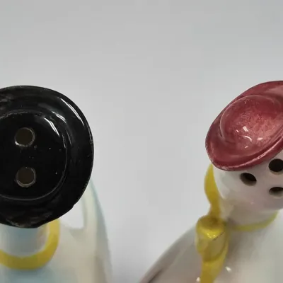 Sale Photo Thumbnail #221: Vintage ceramic duck salt and pepper shakers featuring black and red hats, showing minor finish wear on the brim.