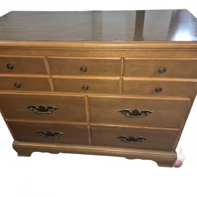 Sale Photo Thumbnail #18: Traditional wooden dresser featuring six upper drawers with knob hardware and four larger lower drawers with brass swing handles.