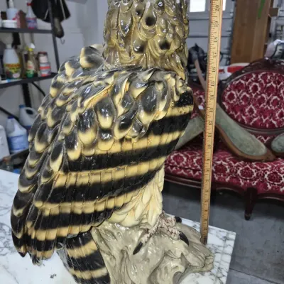 Sale Photo Thumbnail #114: Large vintage glazed ceramic owl statue, measuring approximately 22 inches tall and detailed with textured feathers and dark stripes.