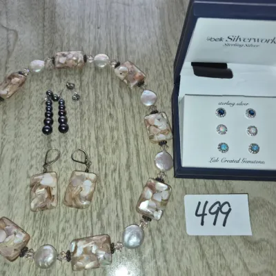 Sale Photo Thumbnail #859: Collection of fine and fashion jewelry featuring a mother-of-pearl segment necklace with matching earrings, dark pearl dangle earrings, and a Belk Silverworks boxed set of lab-created gemstone stud earrings.