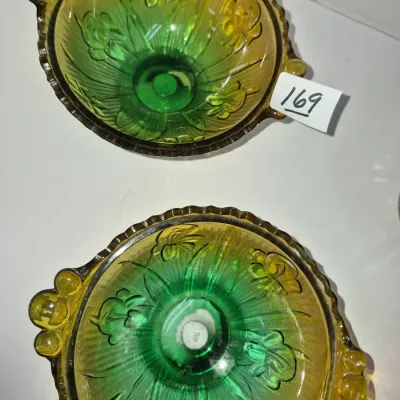 Sale Photo Thumbnail #292: Pair of vintage green and amber ombre Depression glass candy dishes featuring molded floral motifs and double handles.